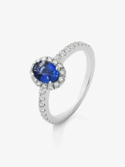 Anillo de oro blanco de 18K con zafiro azul en talla oval de 0,91 cts y orla de diamantes en talla brillante con un total de 0,37 cts