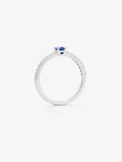 Anillo de oro blanco de 18K con zafiro azul en talla oval de 0,21 cts y 16 diamantes en talla brillante con un total de 0,2 cts