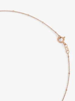 Colgante cadena con estrella de oro rosa de 18K con diamante