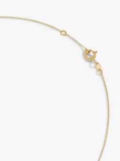 Colgante de oro amarillo de 18K con cruz grande y diamante en talla brillante de 0,01 cts