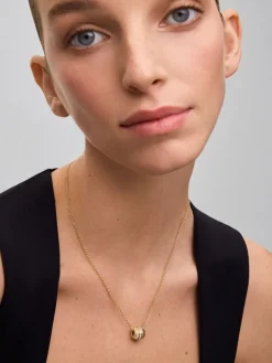 Colgante gallonado de oro blanco y amarillo de 18K con pavé de diamantes en talla brillante con un total de 0,19 cts