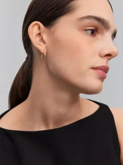 Pendientes de aro de oro amarillo de 18K con diamantes blancos en talla brillante de 0,11 cts y forma de nudo