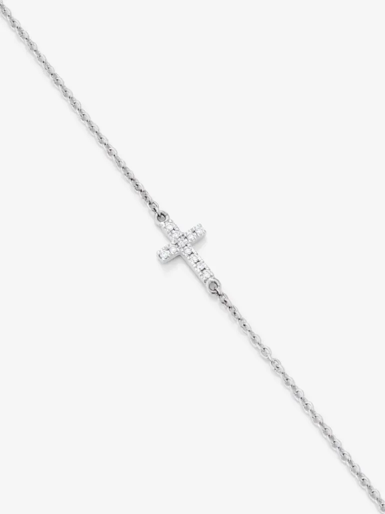 Pulsera de oro blanco de 18K con 11 diamantes en talla brillante con un total de 0,04 cts y cruz