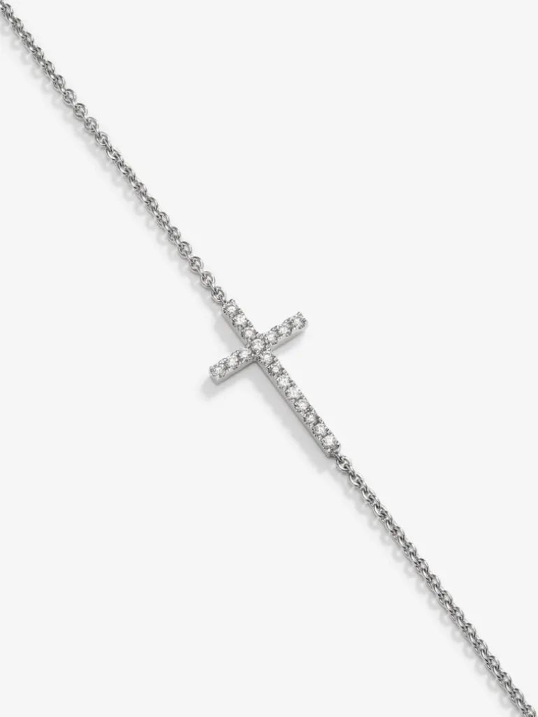 Pulsera de oro blanco de 18K con cruz de diamantes en talla brillante de 0,17 cts