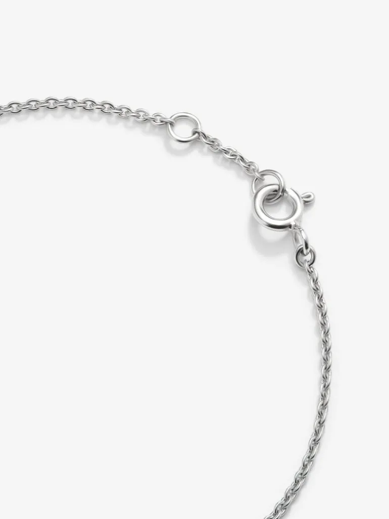 Pulsera de oro blanco de 18K con cruz de diamantes en talla brillante de 0,17 cts