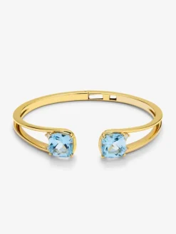 Pulsera rígida de oro amarillo de 18K con 2 topacios azul sky en talla cushion con un total de 0,12 cts