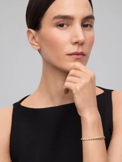 Pulsera rígida de oro amarillo de 18K con diamantes blancos en talla brillante de 0,58 cts