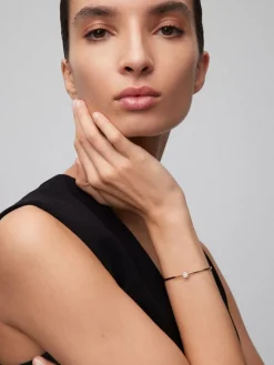 Pulsera r&iacute;gida de oro rosa de 18K con 11 diamantes en talla brillante con un total de 0,21 cts