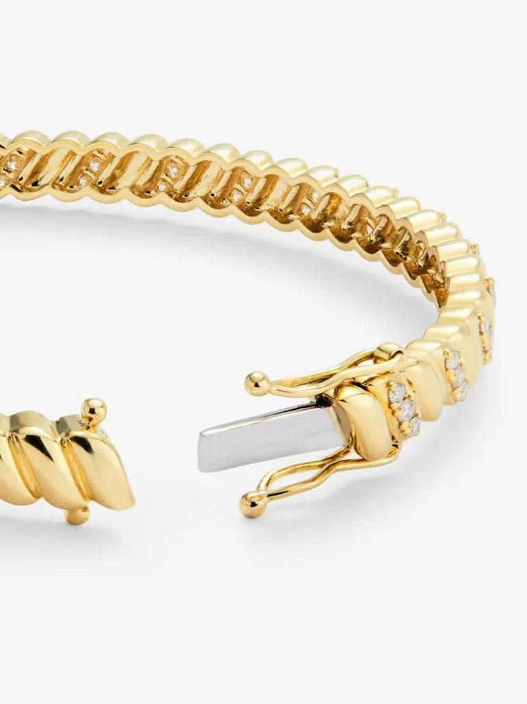Pulsera rígida de oro amarillo de 18K con diamantes blancos en talla brillante de 0,58 cts